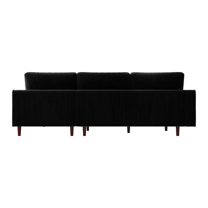 Claude 3 Seater Velvet Sofa with Chaise – Black, featuring black upholstery, wooden legs, and plush cushions. The sofa's spacious chaise design and luxurious velvet fabric offer elegant comfort.