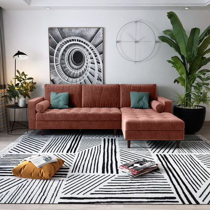 Claude 3 Seater Velvet Sofa with Chaise – Blush, featuring plush cushions and a spacious chaise design, prominently displayed in a cozy interior setting with surrounding stylish furnishings.