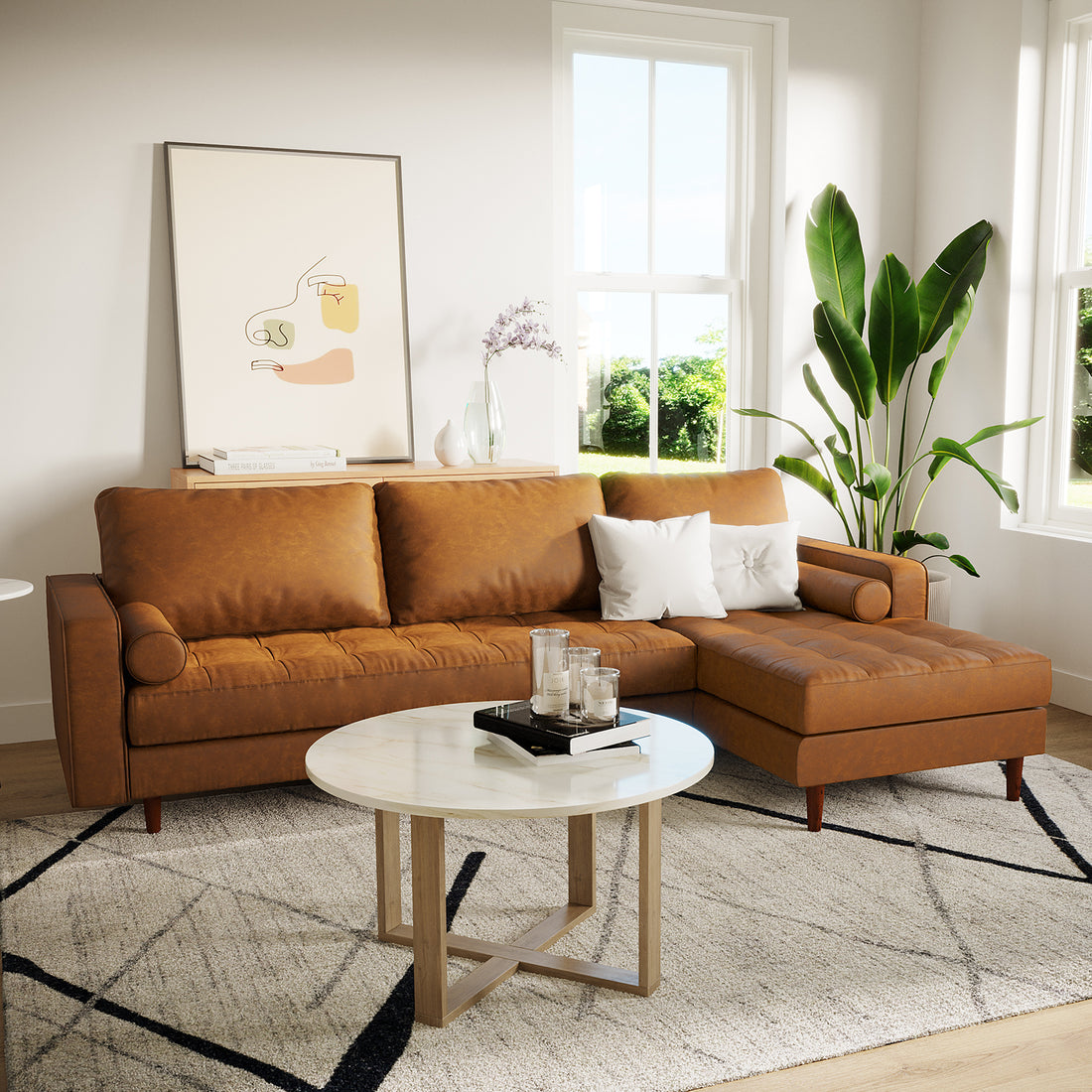 Claude 3 Seater PU Leather Sofa with Chaise in Tan Brown, featuring tufted cushions, two white pillows, and a sleek, L-shaped design, is set in a stylish, naturally-lit living room.