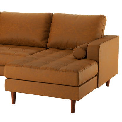 Claude 3 Seater PU Leather Sofa with Chaise in Tan Brown features a mid-century design with tufted cushions, straight armrests, a cylindrical bolster pillow, and tapered wooden legs, offering both style and comfort.