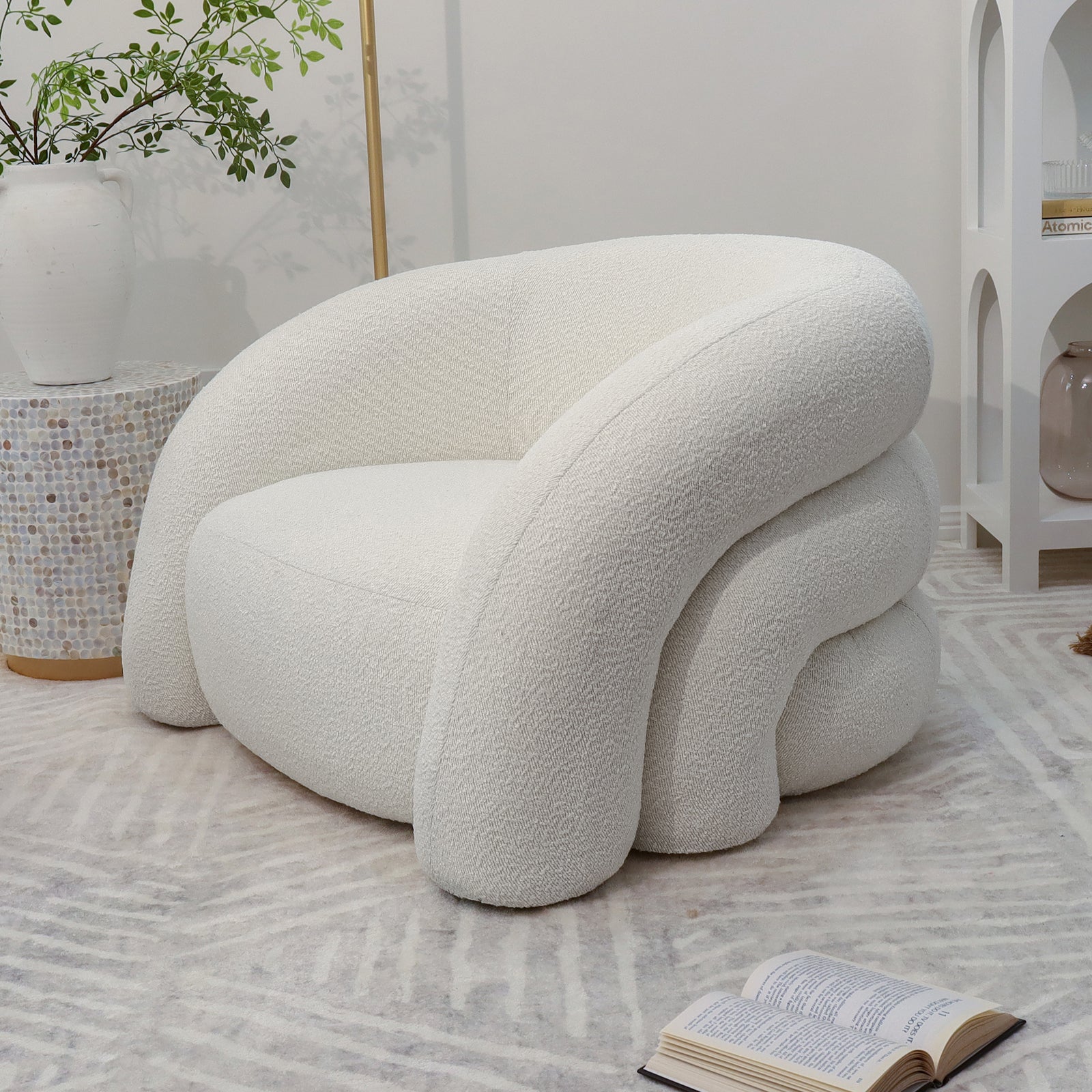 Clioz Bouclé Accent Armchair in eggshell white, featuring plush high-density foam cushions and a solid wood frame, showcased with a white chair in a room setting.