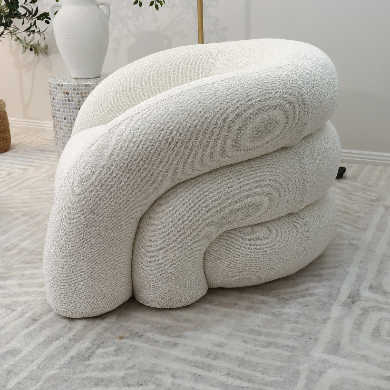 Clioz Bouclé Accent Armchair in eggshell white, showcasing plush cushions and a soft, textured fabric, perfectly blending mid-century design with modern elegance and comfort.