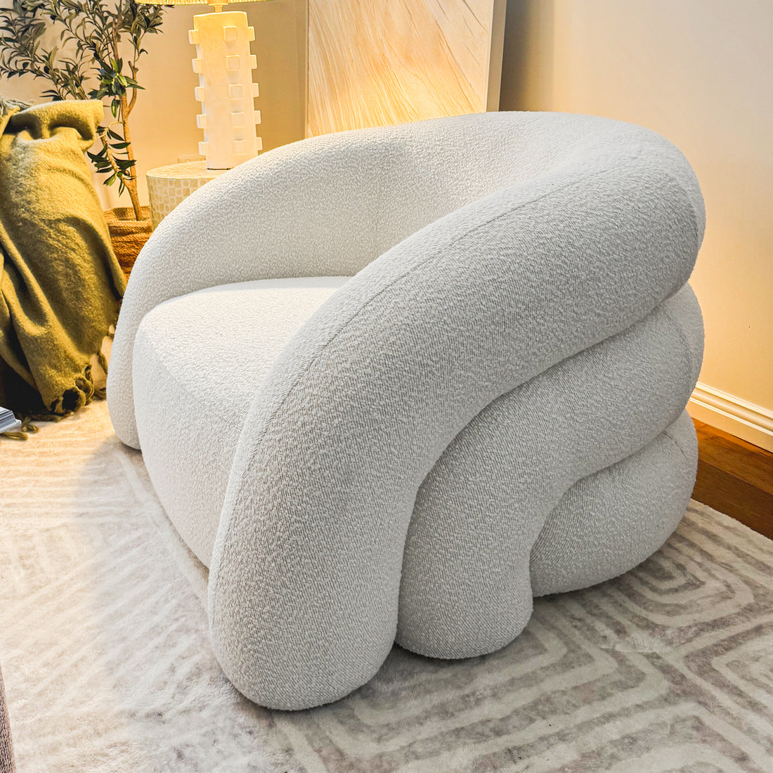 Clioz Boucle Accent Armchair - Eggshell White: Close-up of a mid-century designed armchair with soft boucle fabric, high-density foam cushions, and a solid wood frame, showcasing its elegant and inviting look.