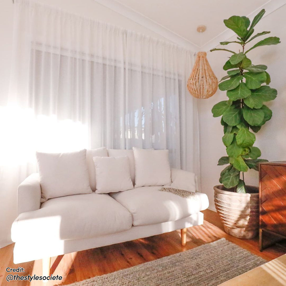 Colton 3-Seater Fabric Sofa Cream White showcased in a cozy setting, featuring plush cushions and a sleek design, perfect for modern interiors.