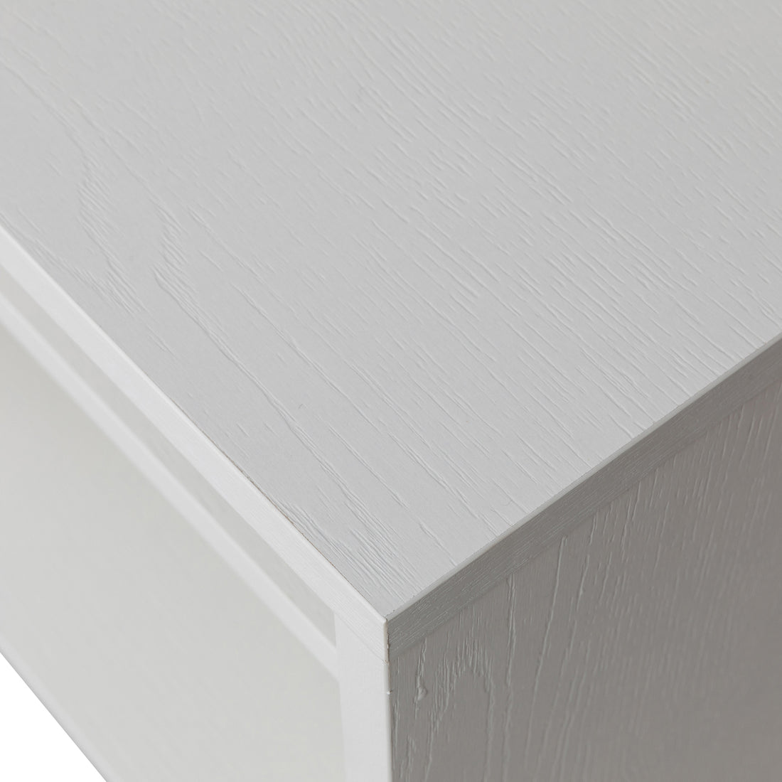 Close-up of Colton Living Room Package's white wood-grain cabinet corner, showcasing the painted surface and precise panel joints, highlighting craftsmanship and elegance in the design.
