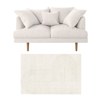 Colton 2 Seater Sofa with Rug in Cream White Fabric, featuring a modern loveseat with three pillows, light cream upholstery, tapered wooden legs, on a neutral-toned geometric pattern rug, perfect for contemporary spaces.