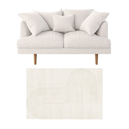 Colton 2 Seater Sofa with Rug in Cream White Fabric, featuring a modern loveseat with three pillows, light cream upholstery, tapered wooden legs, on a neutral-toned geometric pattern rug, perfect for contemporary spaces.