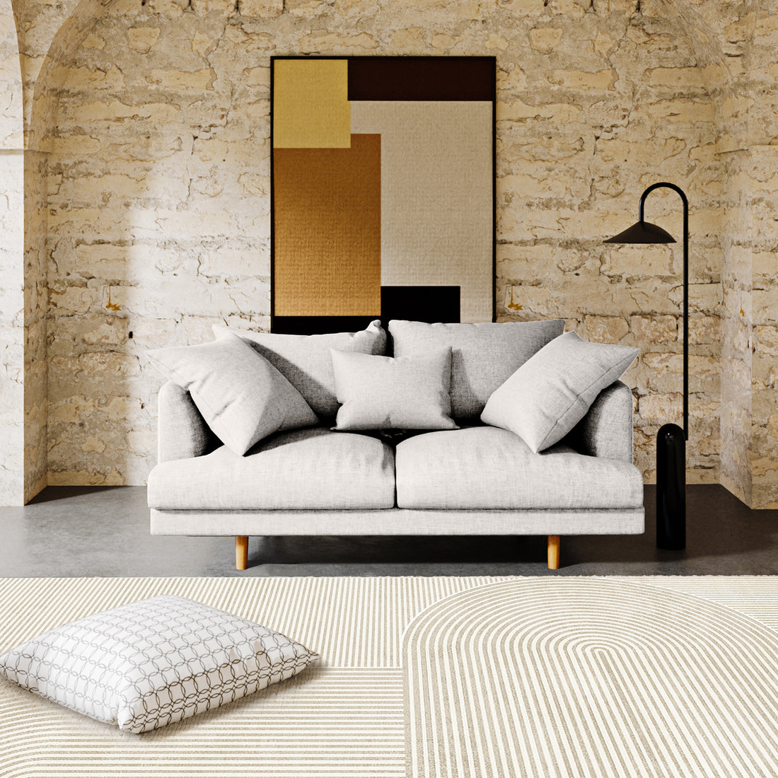 Colton 2 Seater Sofa with Rug in Cream White Fabric, featuring soft cushions, a black-metal floor lamp, and a modern abstract pattern rug, set against a textured wall with arches.