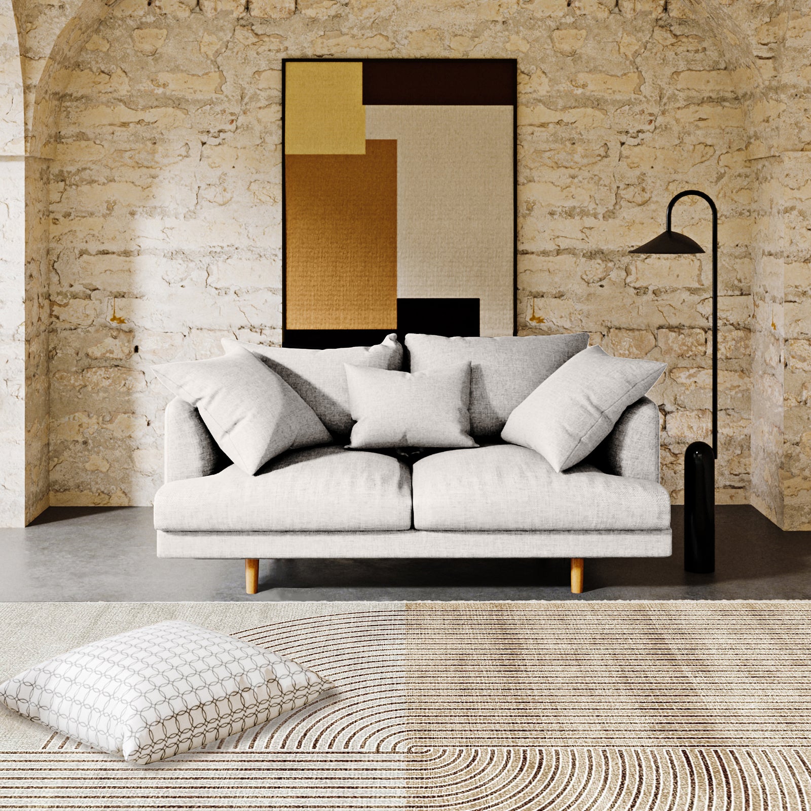 The Colton 2 Seater Fabric Sofa with Rug - Cream White features a minimalist design with a light gray upholstery, three throw pillows, and pairs elegantly with a modern abstract floor rug.