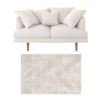 Colton 2 Seater Fabric Sofa with Rug - Cream White: A modern loveseat with four cushions, light upholstery, and a geometric-patterned rug beneath, set against a plain background for a sleek catalog presentation.