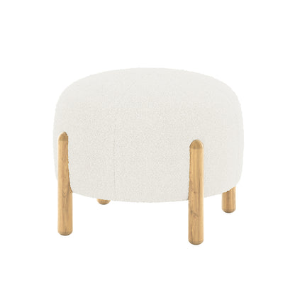 Conchita Boucle Ottoman Stool featuring an off-white, softly rounded upholstered top in bouclé fabric, with four short cylindrical wooden legs extending into the cushion for stylish durability.