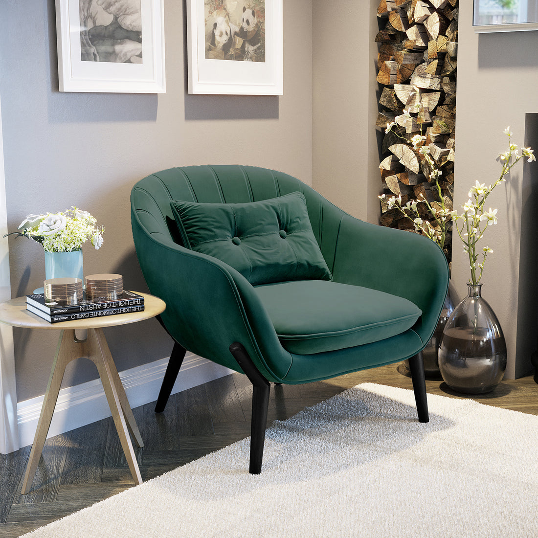 Ellen Velvet Accent Armchair in Dark Forest Green, featuring velvet upholstery and a matching tufted pillow, sits beside a light-wood side table with flowers and books in a cozy reading nook.