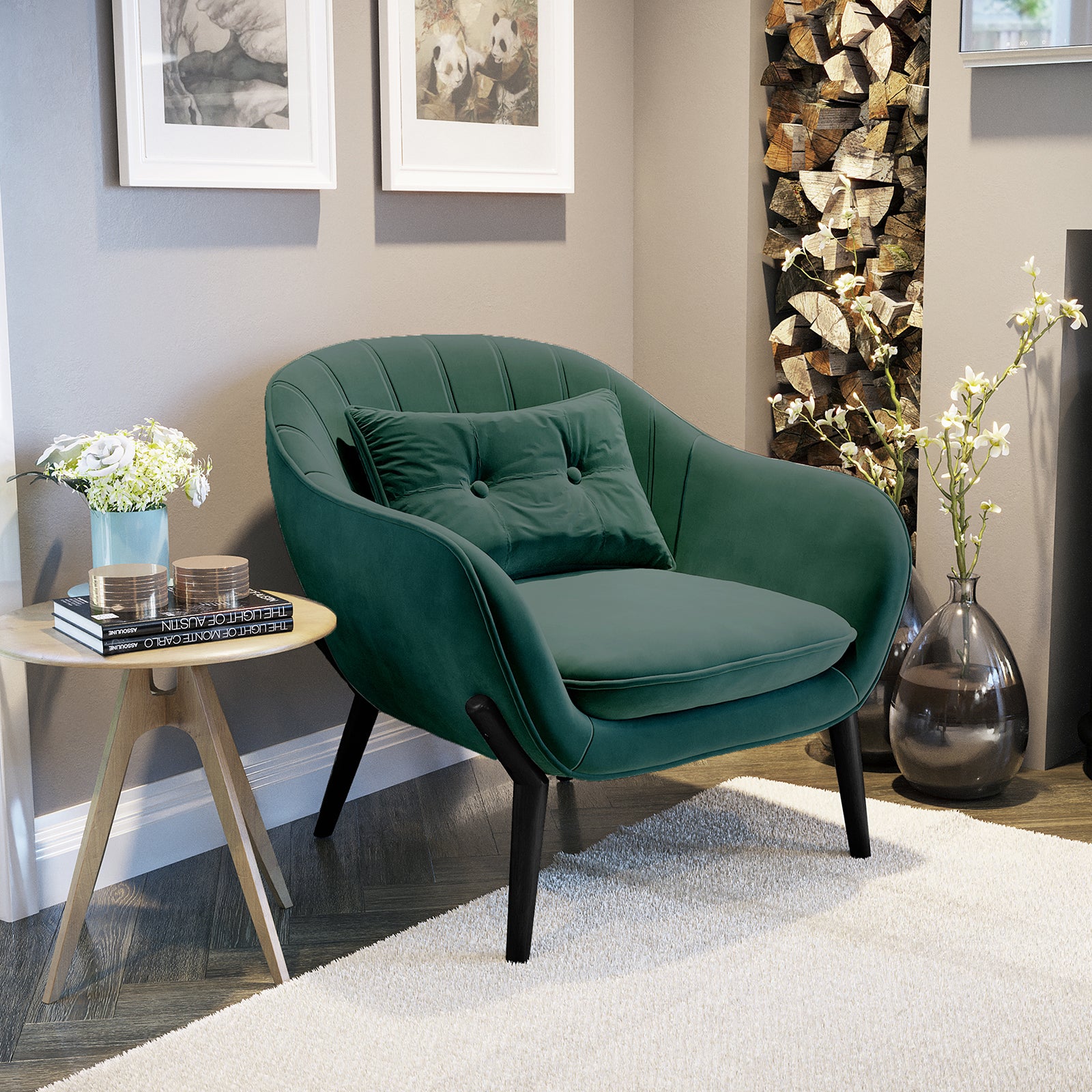 Ellen Velvet Accent Armchair in Dark Forest Green, featuring velvet upholstery and a matching tufted pillow, sits beside a light-wood side table with flowers and books in a cozy reading nook.