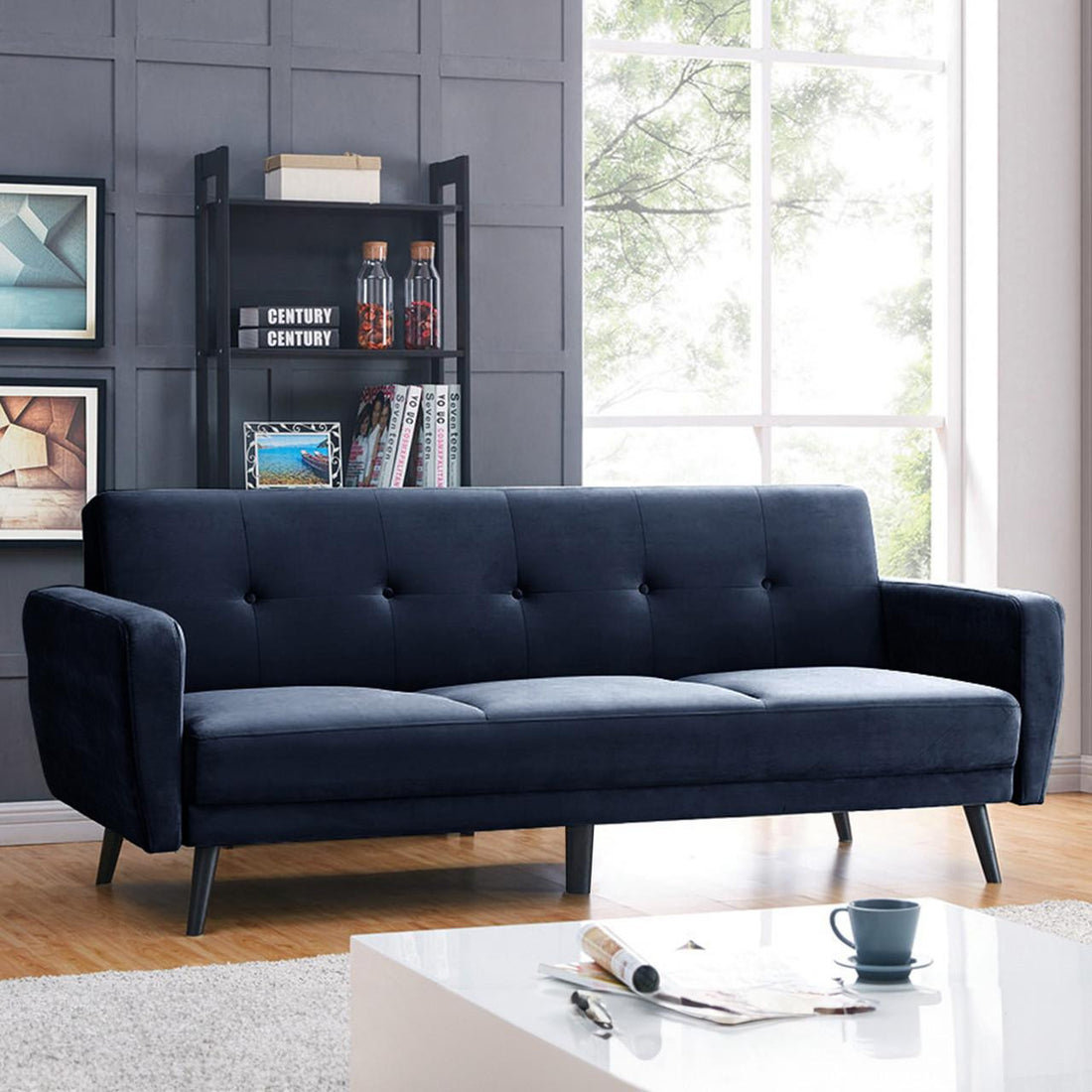 Esben 3-Seater Velvet Sofa Bed in Navy Blue, featuring a sleek design with rolled arms and wooden legs. Ideal for modern interiors, it easily converts into a bed for guests.