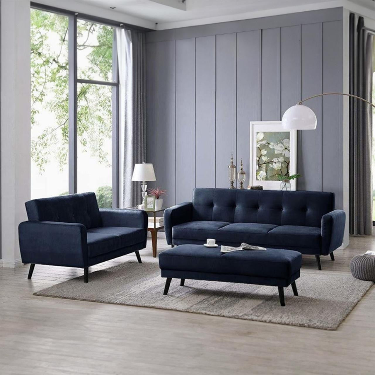 Esben Velvet Fabric Ottoman in Navy Blue, featured in a modern living room, showcases a plush, rectangular design with Scandinavian-style wooden legs, positioned on a light-grey rug.