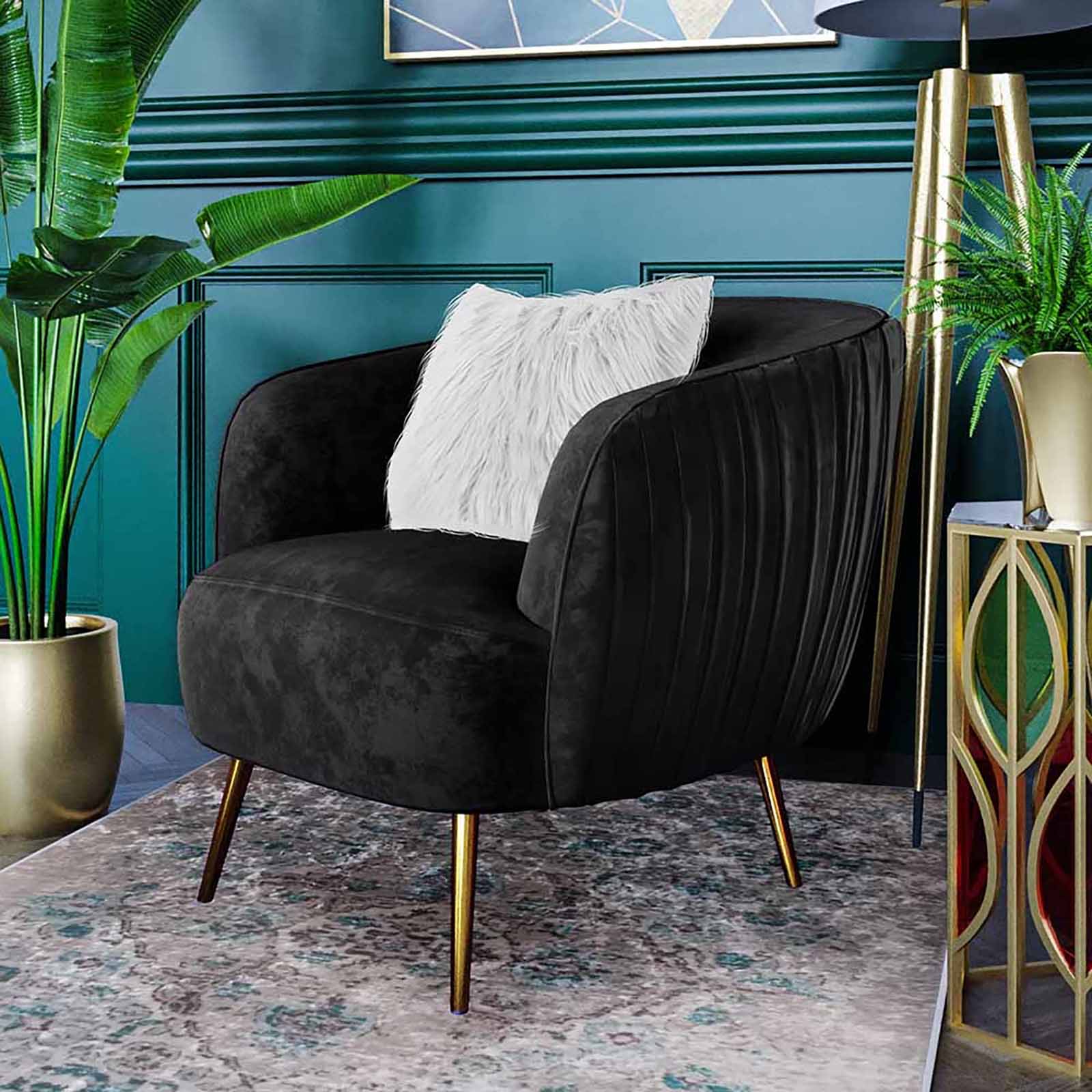 Evelyn Curved Velvet Sofa Accent Chair in Black features a channel-tufted back, gold metal legs, and a fluffy white throw pillow, set against teal walls with gold side table and lush plant.