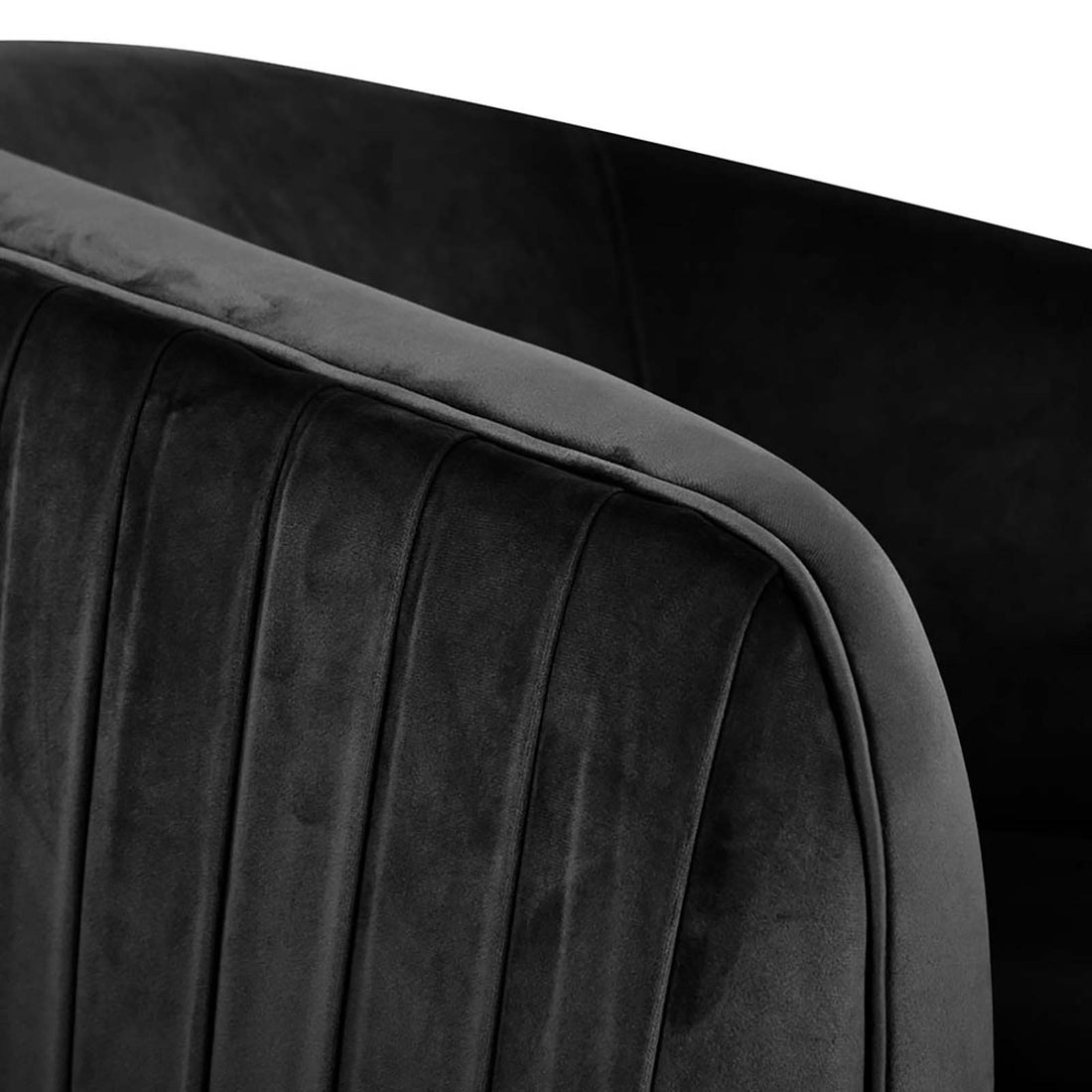 Evelyn Curved Velvet Sofa Accent Chair in Black, showcasing a close-up of its channel-tufted design with a gracefully curved arm and back, exemplifying mid-century modern elegance and luxurious texture.