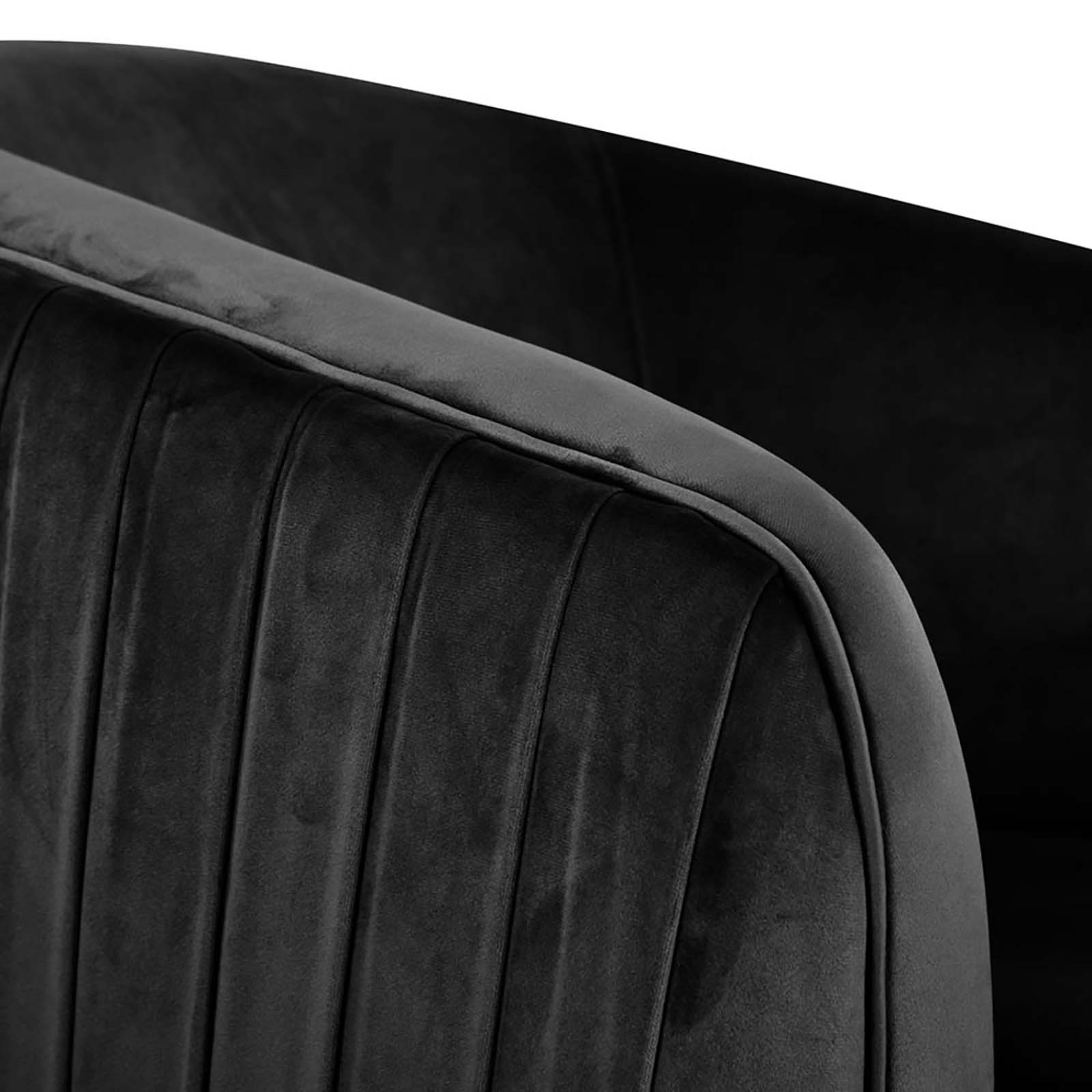Evelyn Curved Velvet Sofa Accent Chair in Black, showcasing a close-up of its channel-tufted design with a gracefully curved arm and back, exemplifying mid-century modern elegance and luxurious texture.
