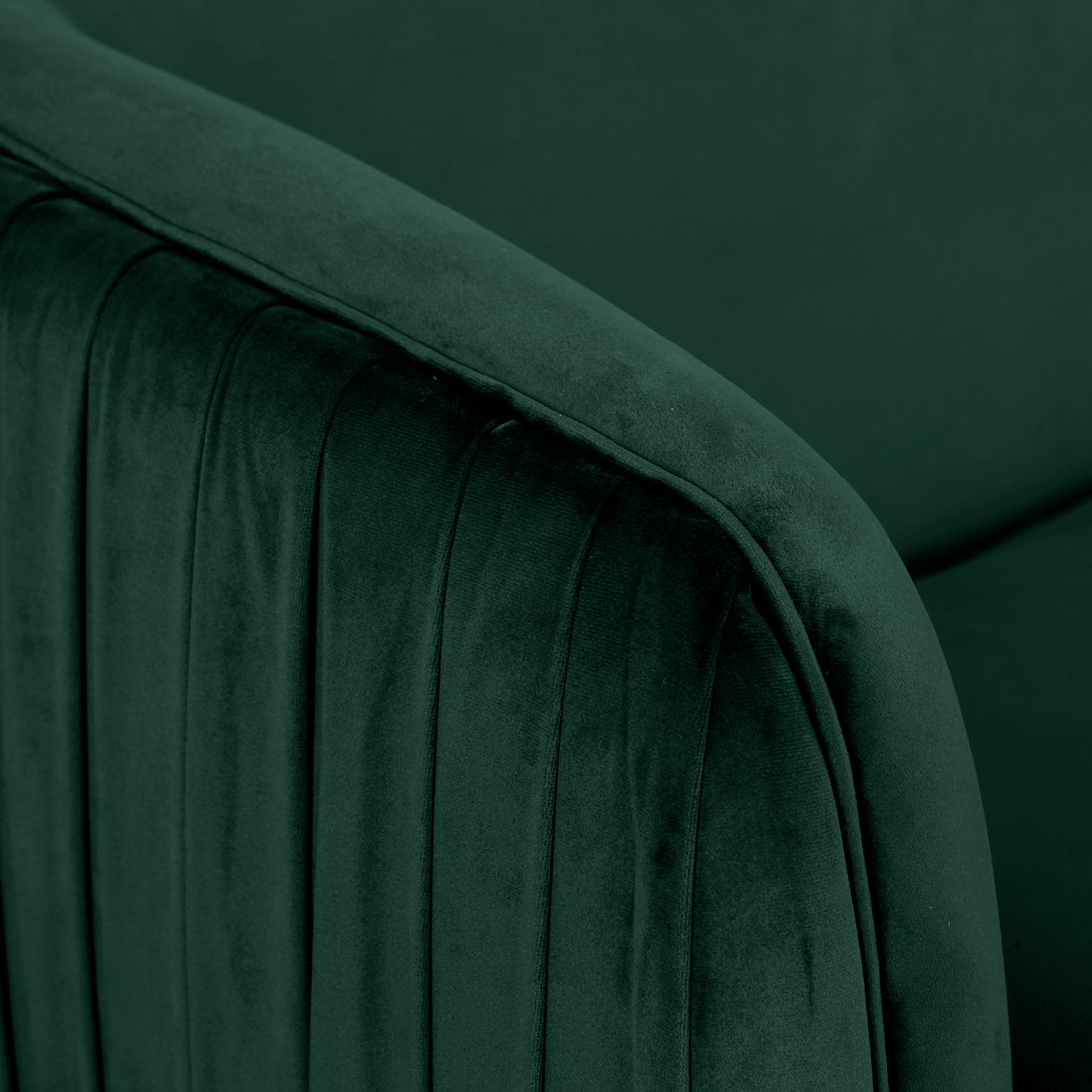 Close-up of the Evelyn 4 Seater Velvet Sofa Set in Dark Green, showcasing plush velvet fabric with vertical channel-stitched detailing on a rounded, padded armrest, highlighting its luxurious texture and craftsmanship.