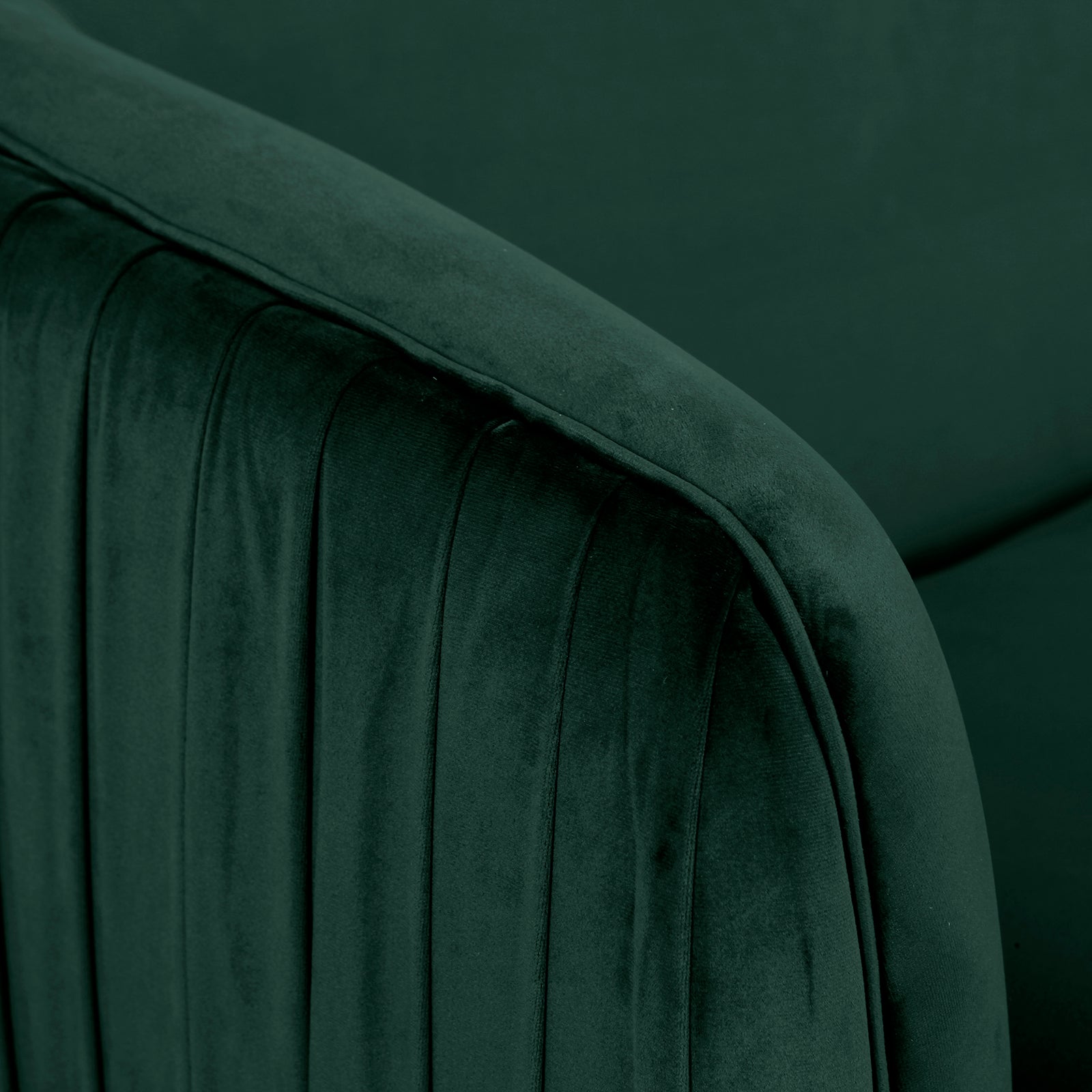 Close-up of the Evelyn 4 Seater Velvet Sofa Set in Dark Green, showcasing plush velvet fabric with vertical channel-stitched detailing on a rounded, padded armrest, highlighting its luxurious texture and craftsmanship.