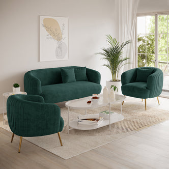 Evelyn 4 Seater Velvet Sofa Set in Dark Green, featuring a plush velvet finish with gold-toned metal legs, accompanied by matching armchairs, set in a chic, light-filled living room corner.