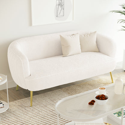 Evelyn 2 Seater Curved Boucle Sofa in Cream White, featuring a low, elegant design with slim brass-tone legs, adorned with two linen cushions, set in a minimalist Scandinavian-style living area.