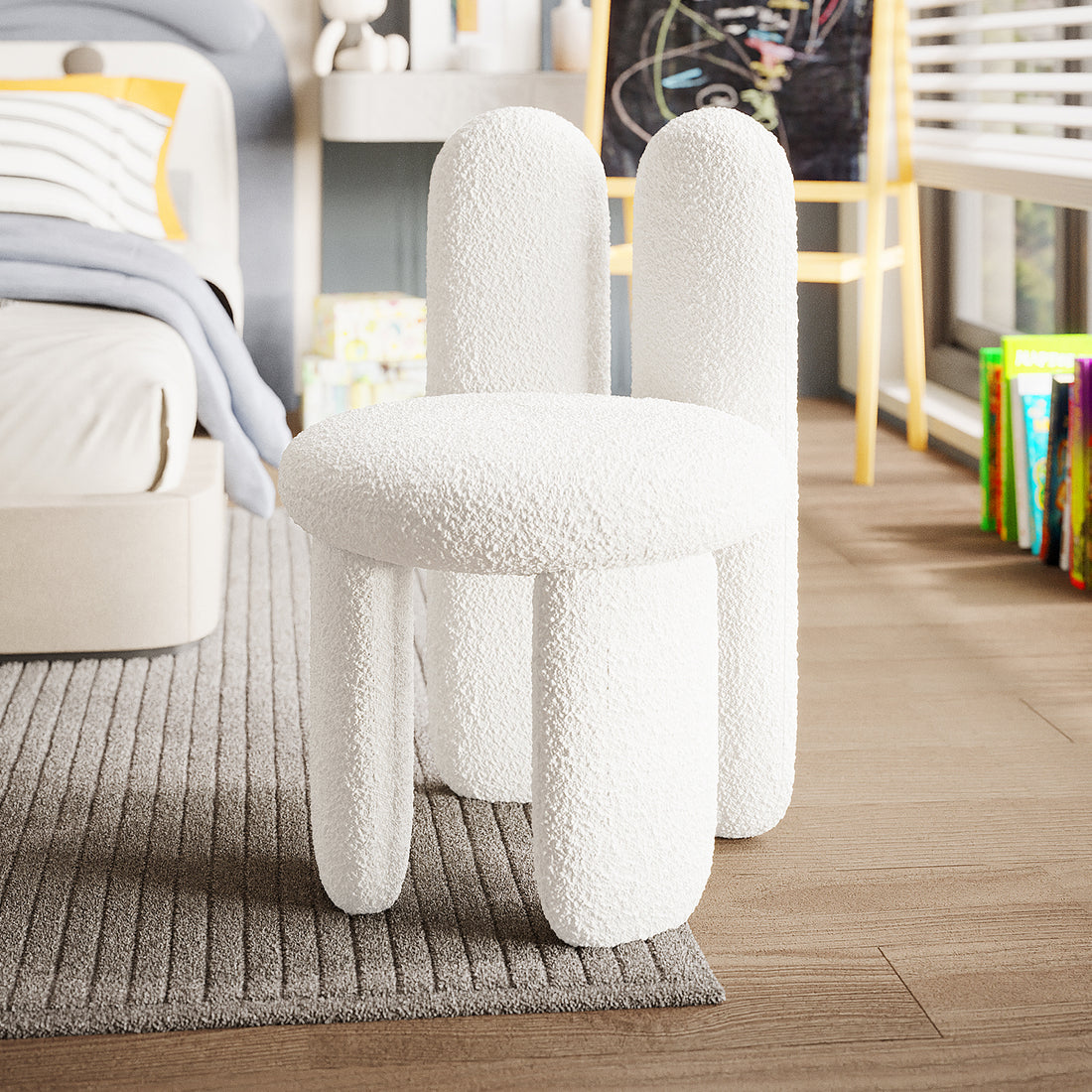 Flore Boucle Kids Chair with Bunny Ears in Cream White, featuring a playful bunny-shaped backrest and soft boucle upholstery, sits on a rug in a child's bedroom, surrounded by books and toys.