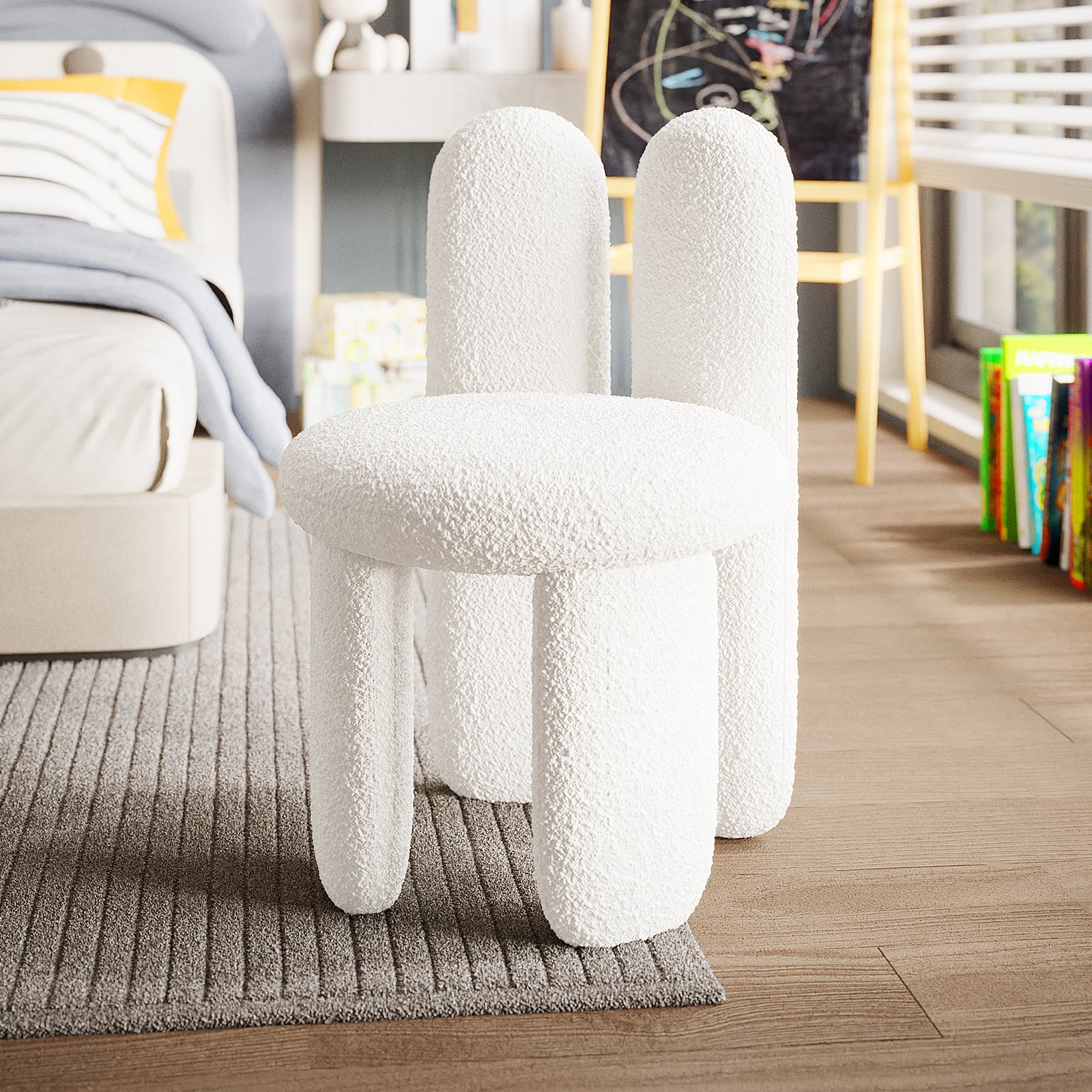 Flore Boucle Kids Chair with Bunny Ears in Cream White, featuring a playful bunny-shaped backrest and soft boucle upholstery, sits on a rug in a child's bedroom, surrounded by books and toys.
