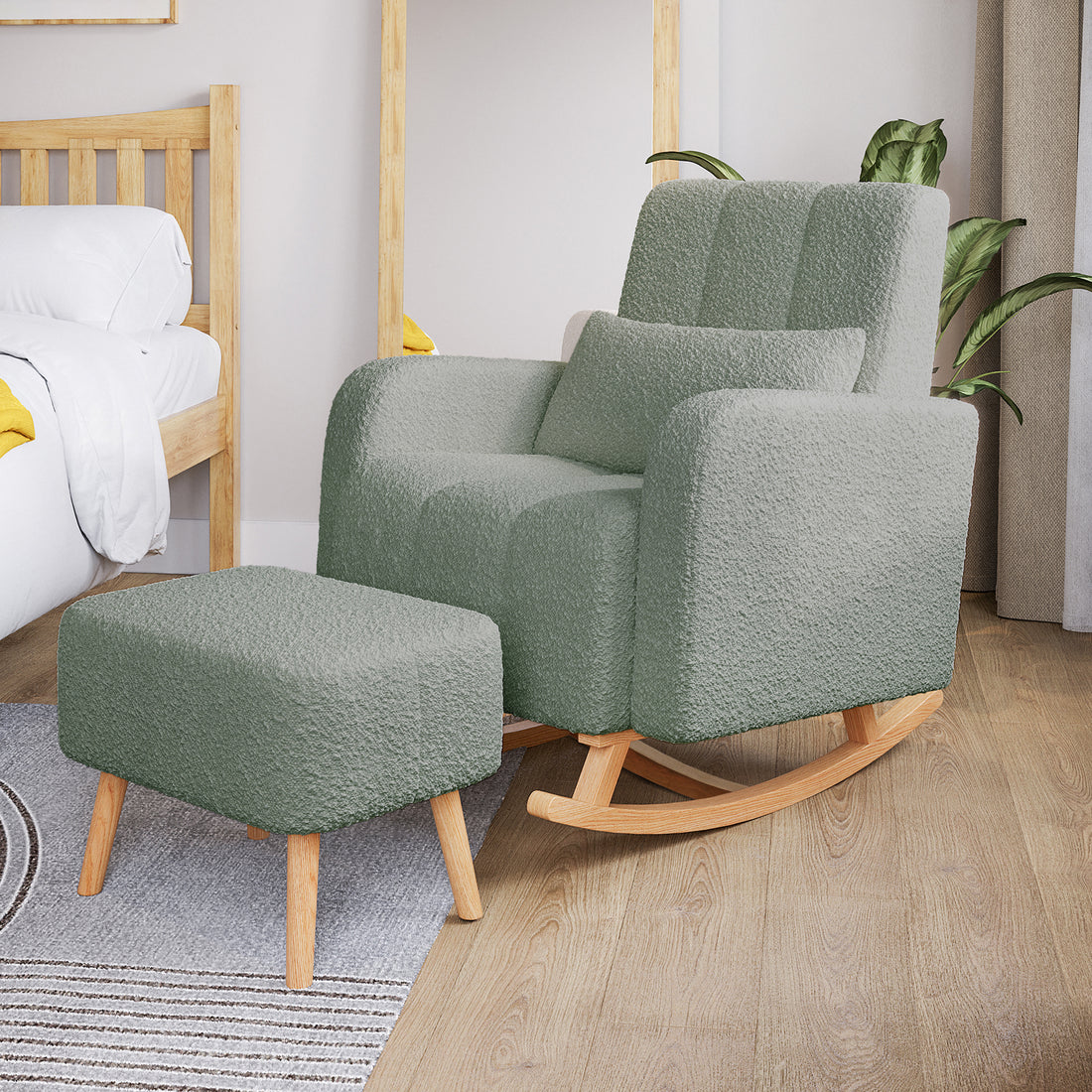 Gamila Boucle Rocking Chair with Ottoman in Mint Green, featuring a sage-green bouclé upholstery, light wood legs, and rockers. Set on a wood-floor bedroom next to a bed and mirror.
