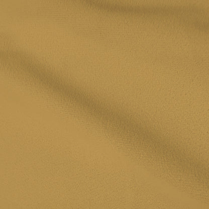 Close-up of smooth mustard gold fabric upholstery with a soft, matte finish.   