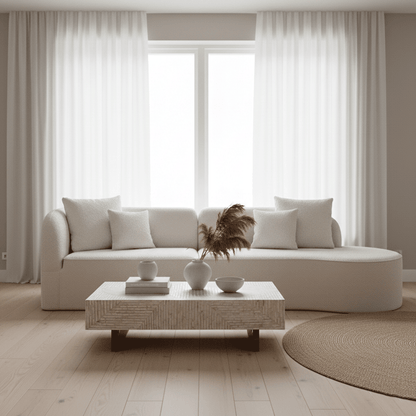 Hattie 4 Seater Boucle Sofa in Cream White, showcasing its curving design, plush texture, and matching throw pillows, sits invitingly in a bright, minimal-modern living room with ocean views.