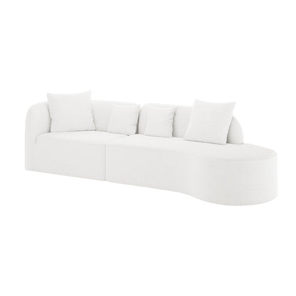 Hattie 4 Seater Boucle Sofa in Cream White, featuring a modern, all-white upholstered sectional design with a straight seat, curved chaise end, and four matching throw pillows on a white background.