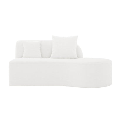 Hattie 4 Seater Boucle Sofa in Cream White with a minimalist, curved profile, textured fabric, low arched backrest, and two matching throw pillows. Sits directly on the floor, offering luxurious comfort.