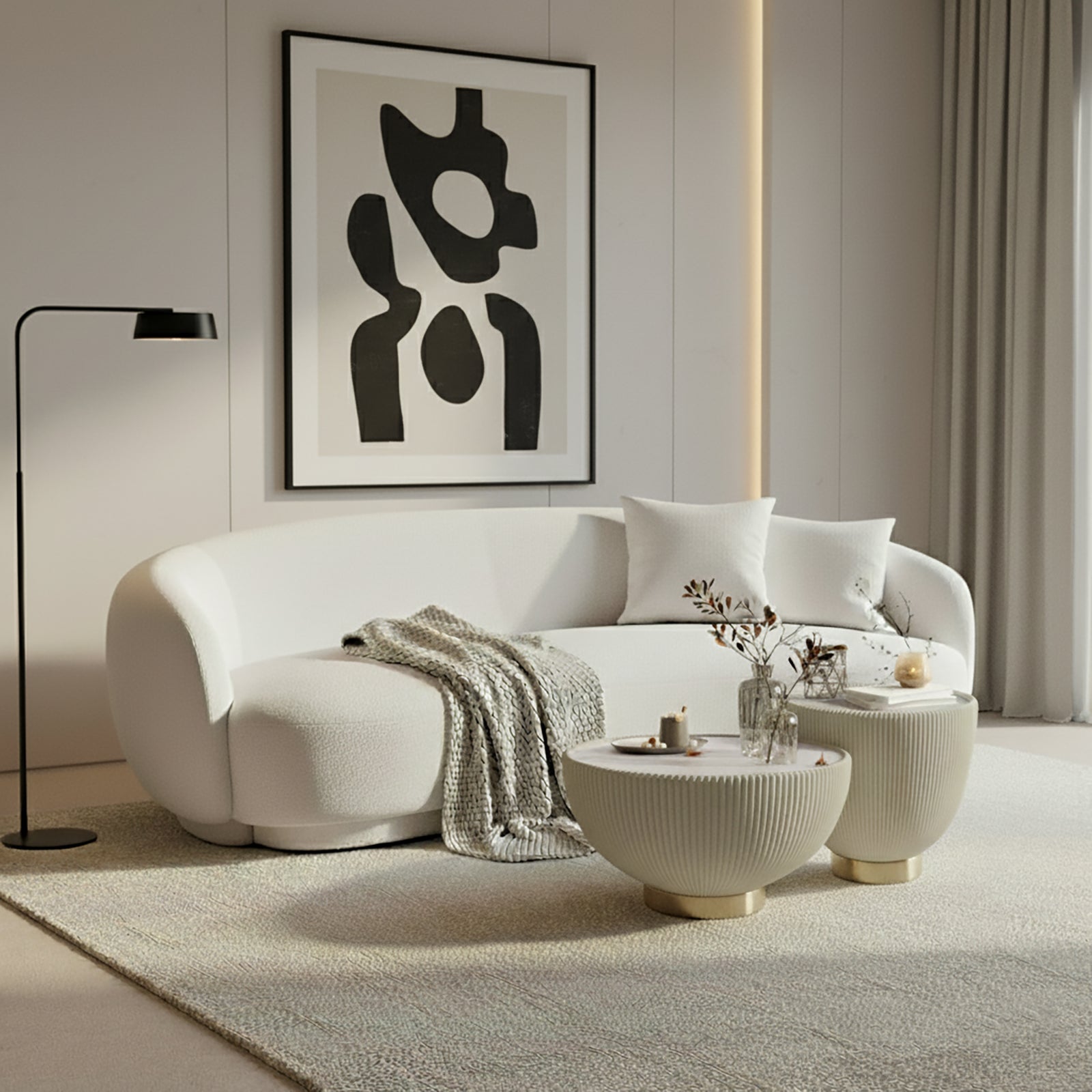 Janelle 213cm Curved Bouclé 3.5-Seater Sofa in Cream White, featuring plush throw pillows, a beige knitted blanket, and a solid wood frame, set in a minimalist living area.