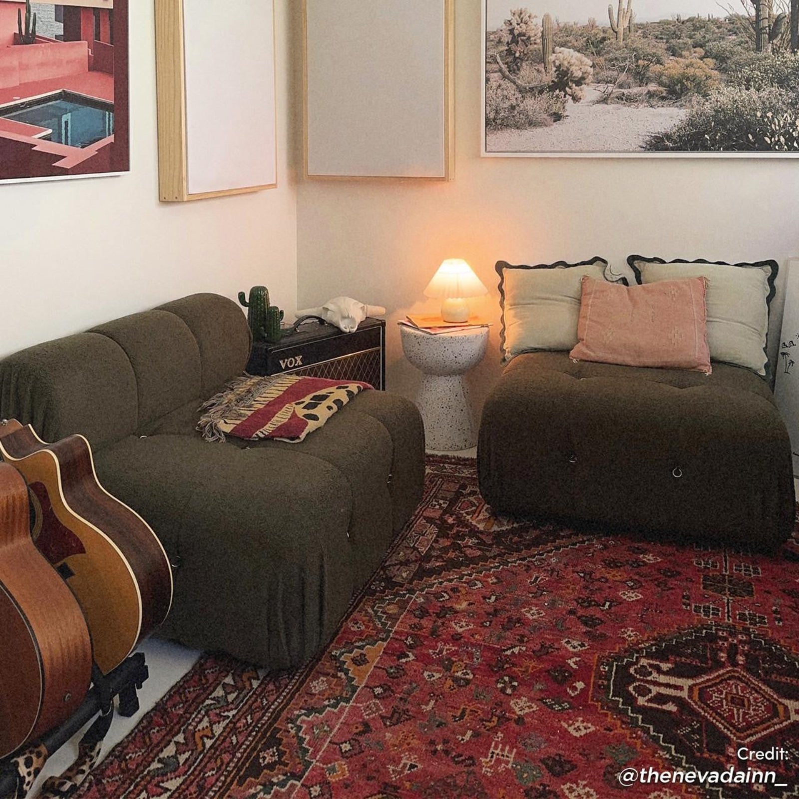 Cozy music lounge with Keila Modular Tufted Boucle Ottoman in Green, surrounded by olive-green chairs, guitars, a VOX amp, and a Persian rug, creating a relaxed, stylish atmosphere.