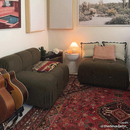 Cozy music lounge with Keila Modular Tufted Boucle Ottoman in Green, surrounded by olive-green chairs, guitars, a VOX amp, and a Persian rug, creating a relaxed, stylish atmosphere.
