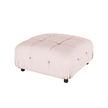 Keila Modular Tufted Velvet Ottoman features a blush-pink square design with a tufted cushion top and small metal rings, supported by four short black legs, offering modern sophistication and versatility.