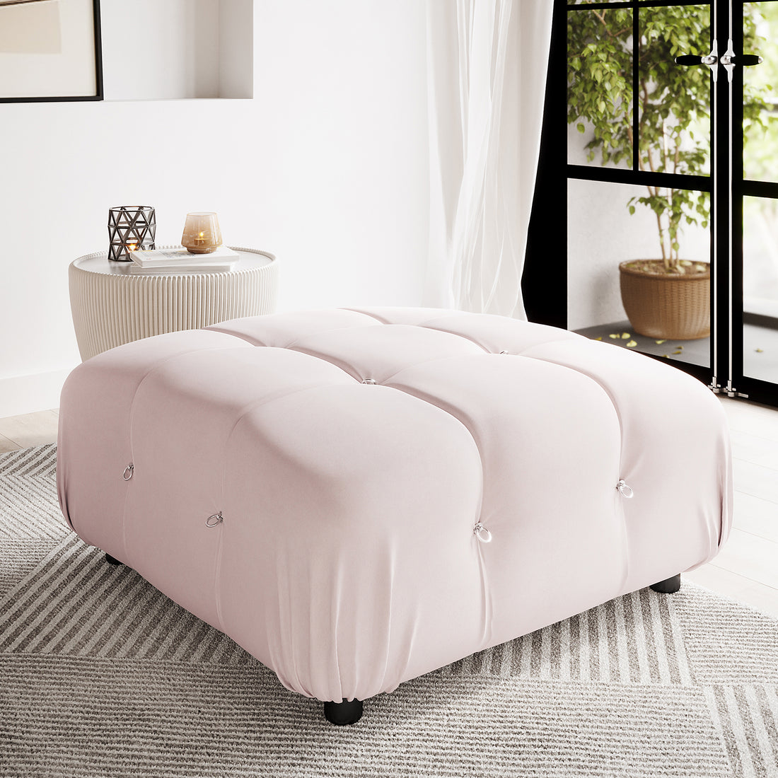 Keila Modular Tufted Ottoman in Cream Velvet, featuring a plush square design with elegant tufted details and subtle metal ring accents, resting on black feet against a light-grey striped rug.