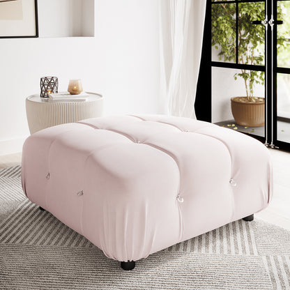 Keila Modular Tufted Ottoman in Cream Velvet, featuring a plush square design with elegant tufted details and subtle metal ring accents, resting on black feet against a light-grey striped rug.