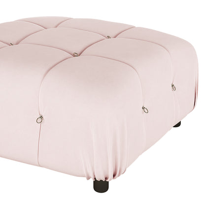 Keila Modular Tufted Velvet Ottoman features a quilted, tufted blush-pink surface with metal ring accents, resting on dark feet. Ideal for seating, footrest, or coffee table use.