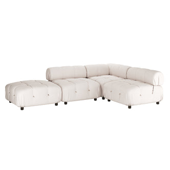 Keila 4 Seater Modular Chaise Sofa Set in Cream Velvet features tufted, low-profile modules with short black legs, cylindrical backrests, and an interchangeable ottoman for flexible L-shaped configurations.
