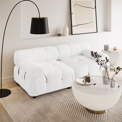 Keila 2 Seater Modular Tufted Boucle Sofa Set in Cream White, featuring textured upholstery, low design, and tufted detailing, placed in a minimalist living room with a ribbed coffee table and arched floor lamp.