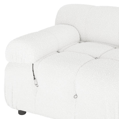 Keila 2 Seater Modular Tufted Boucle Sofa Set features a plush, tufted seat and armrest, decorative metal rings, short cord detail, and a visible black foot, showcasing modern design elegance.