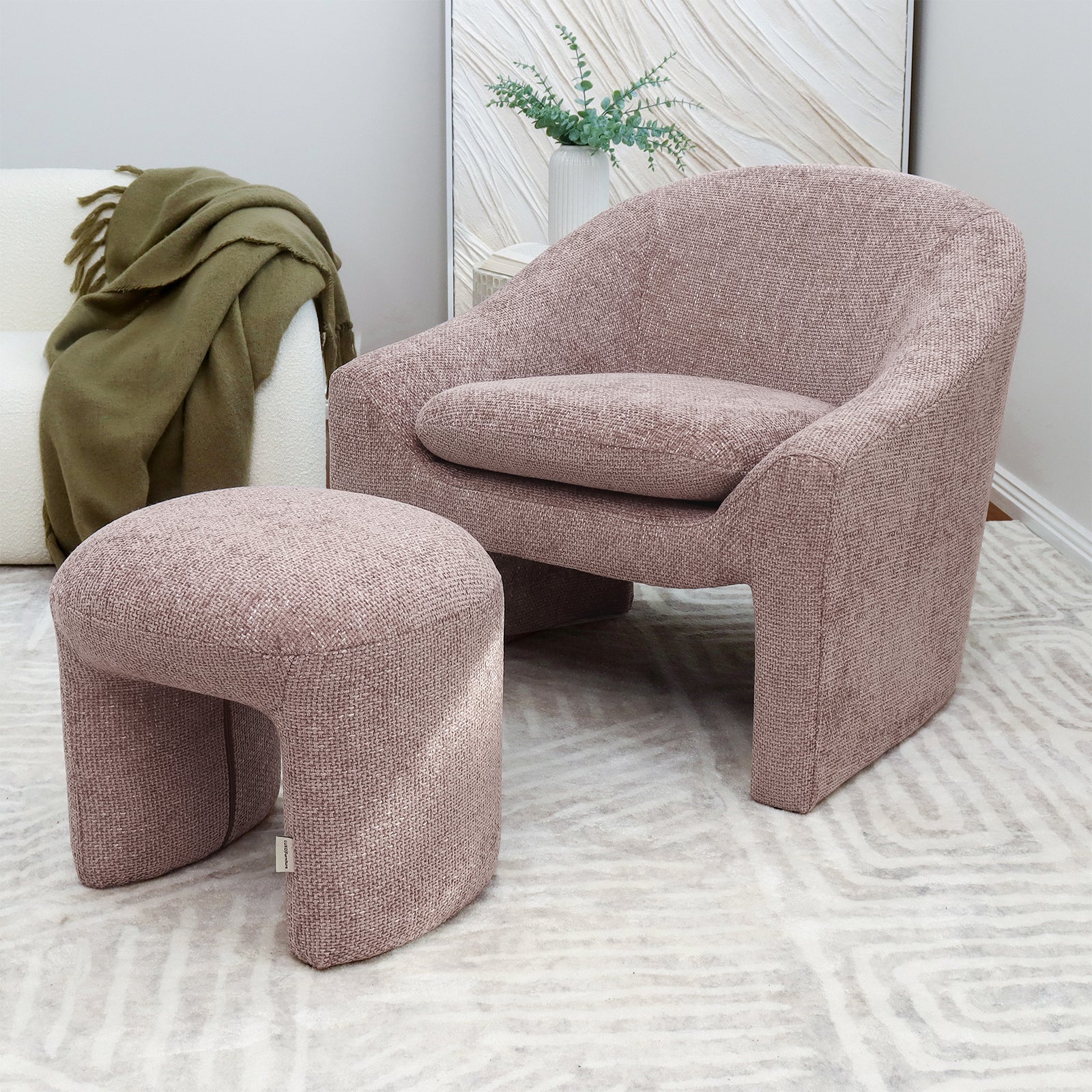 Kotrina Linen Chenille Accent Armchair Light Pink featuring a curved modern design, deep plush cushion, and textured chenille upholstery, displayed with a green blanket on the seat in a stylish room setting.