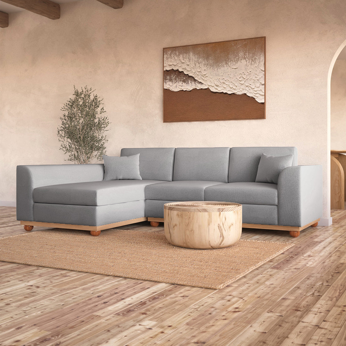 Laylah 3 Seater Fabric Hardwood Sofa with Left Chaise, highlighting its sturdy frame and removable cushions, set in a stylish interior with a visible couch and decor elements.