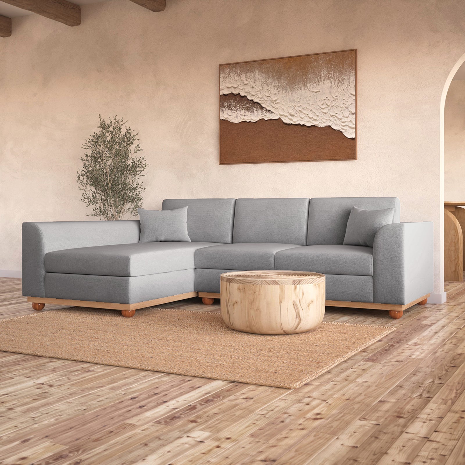 Laylah 3 Seater Fabric Hardwood Sofa with Left Chaise, highlighting its sturdy frame and removable cushions, set in a stylish interior with a visible couch and decor elements.
