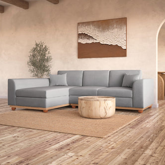 Laylah 3 Seater Fabric Hardwood Sofa with Left Chaise, highlighting its sturdy frame and removable cushions, set in a stylish interior with a visible couch and decor elements.