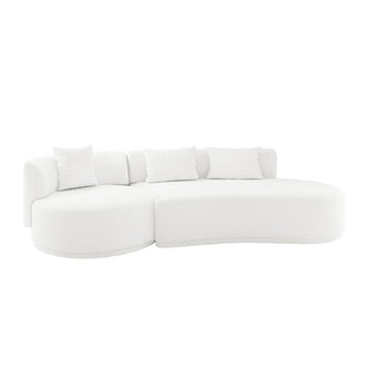 Lyana 4 Seater Boucle Sofa with Right Chaise in Cream White, featuring a modern, all-white curved design, textured boucle fabric, and four matching throw pillows for a sculptural look.