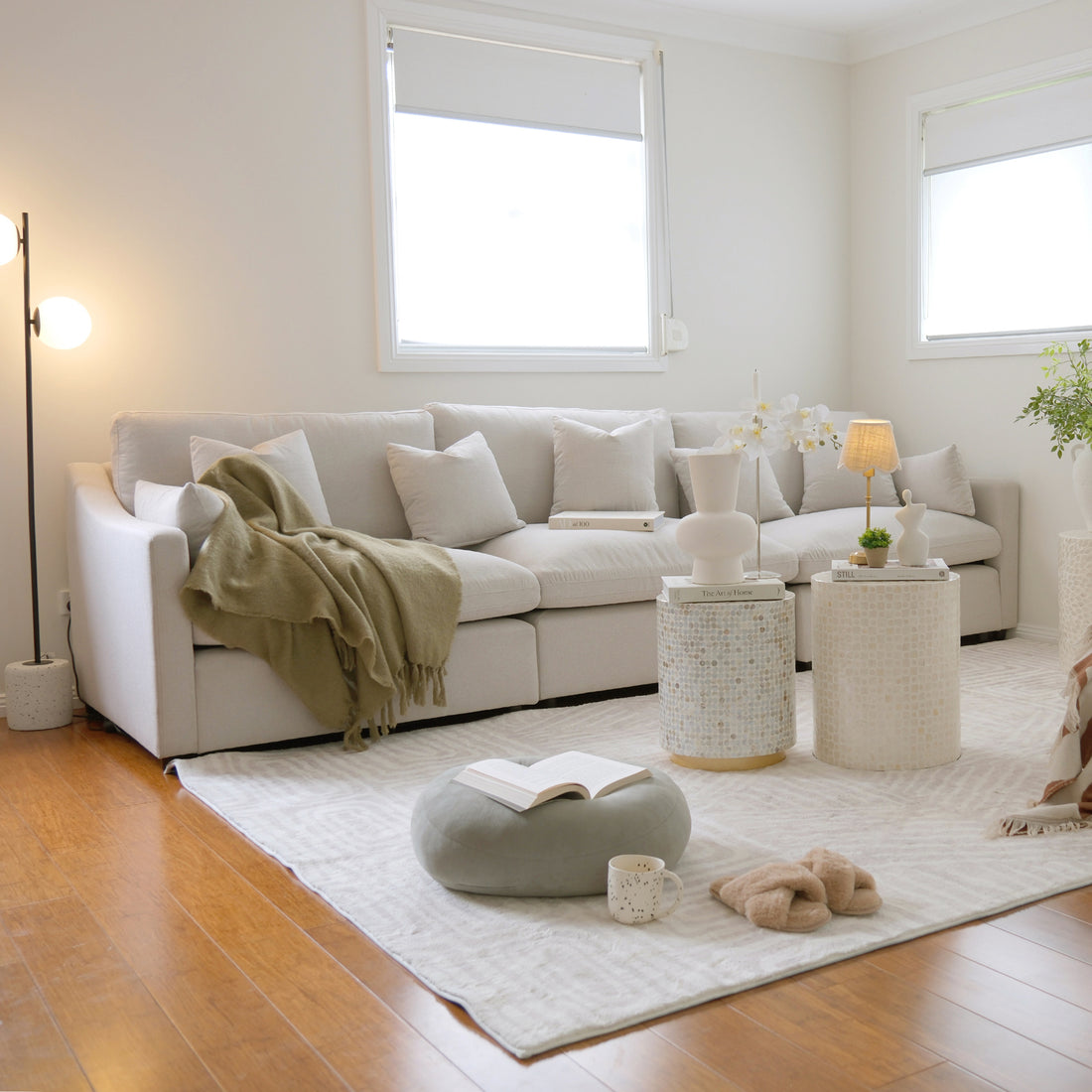 Millie 4-Seater Fabric Modular Sofa Light Beige with deep, inviting seats and a sleek, minimalist design, partly visible on a couch, emphasizing comfort and modern adaptability in living spaces.