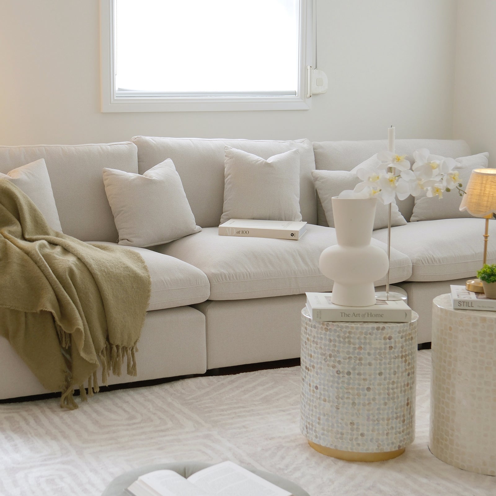 Millie 4-Seater Fabric Modular Sofa Light Beige with clean lines, deep seating, and removable cushions, showcased in a modern interior with a close-up of a white pillow on a couch.